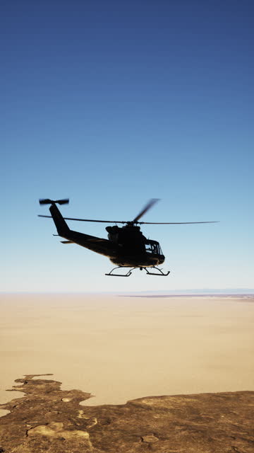 Retro American Military Helicopter Flying Over Desert Landscape