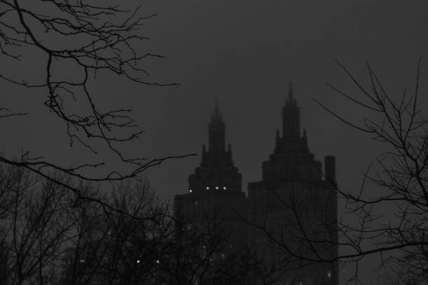 Central Park winter with skyscrapers and Bow Bridge in midtown Manhattan New York City