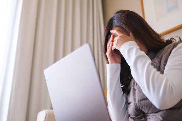 istock A woman get headache and stressed while working online on laptop computer at home 2148105291