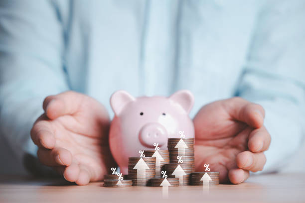 istock Businessman hand protect increasing coins stack with percentage up arrow and piggy saving bank for deposit capital investment growth from investment concept. 2148106122
