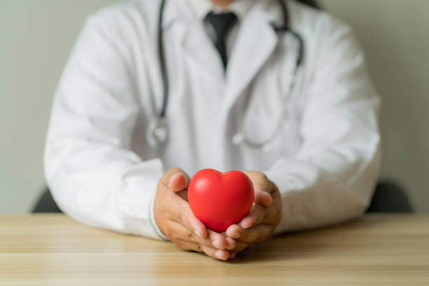 istock Asian male doctor's hand holding a red heart 2148107132