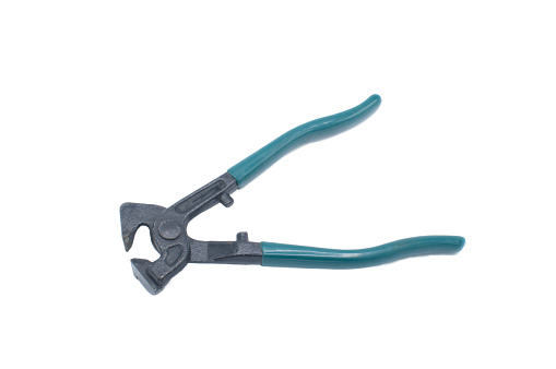 Heavy duty tile nippers cutter tool with green blue rubber grip handles tool used to nip or remove small amounts of a hard material to fit around an odd irregular shape.  Isolated on white background