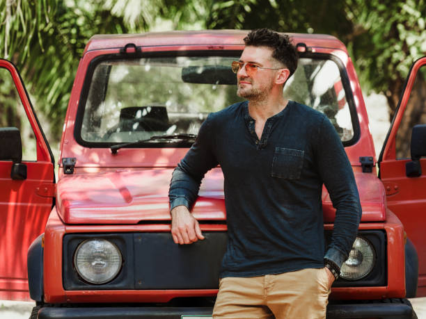 istock Attractive man and a red SUV. Closeup, outdoor 2148108621