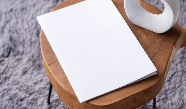 istock blank magazine mockup on coffee table with vase and grey rug 2148108795