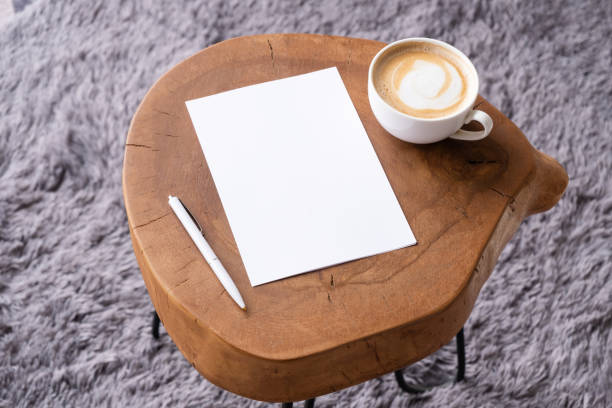 istock blank notepaper mockup on coffee table with cappuccino, pen and grey rug 2148108809