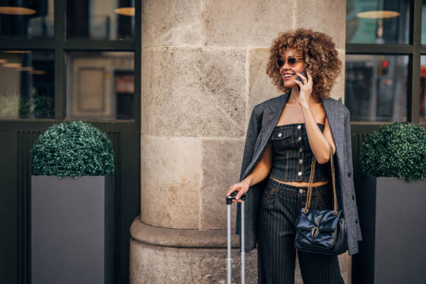 istock Stylish woman talking on phone in urban setting 2148109270