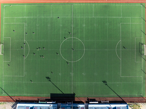 Aerial view of soccer players training on football field. Antalya / Turkey. Taken via drone