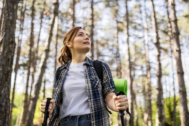 istock An attractive young woman hiking in forest 2148109328