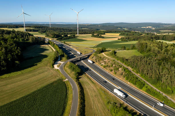 istock Trucks and cars on rural highway 2148109390