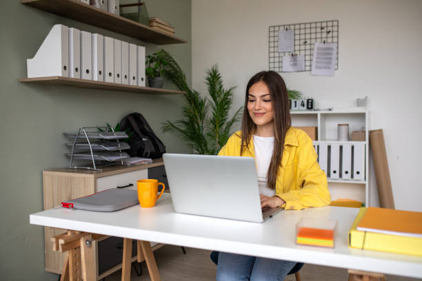 istock Young woman working on a laptop in the office 2148109730