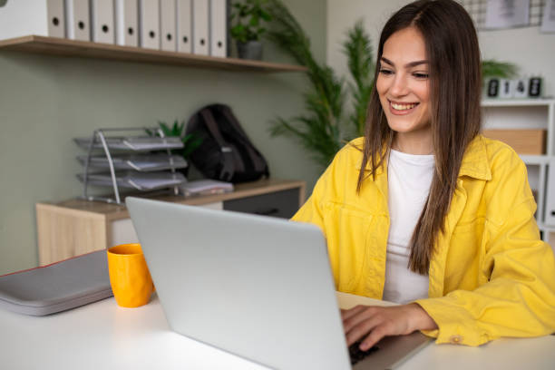 istock Young woman working on a laptop in the office 2148109743