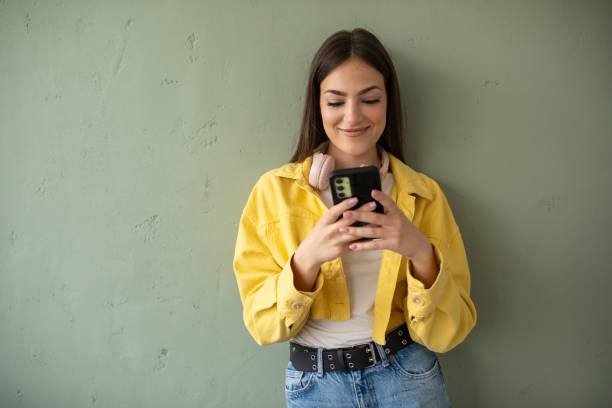 istock Young woman using her phone at home 2148109835