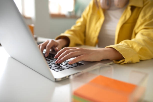 istock Young woman working on a laptop at home 2148109848