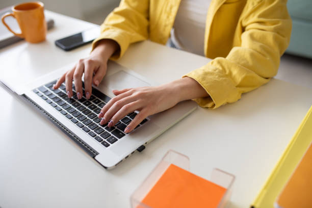 istock Young woman working on a laptop at home 2148109874