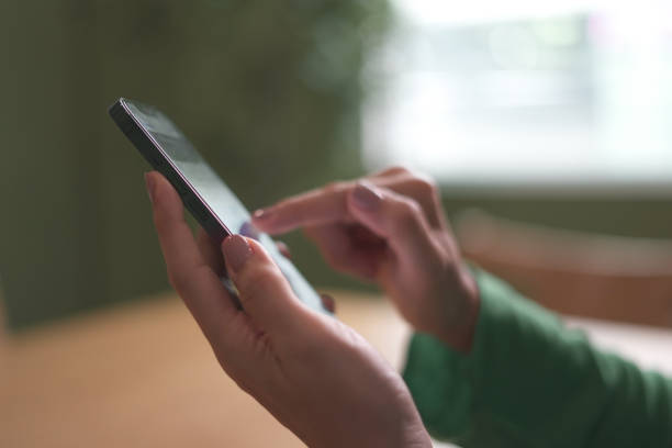 Close-up Finger pressing mobile phone screen