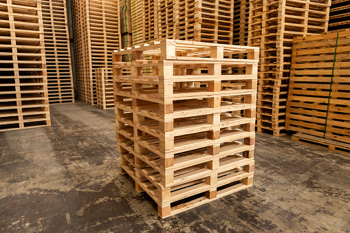 Closeup of a stack of pallets in a warehouse.