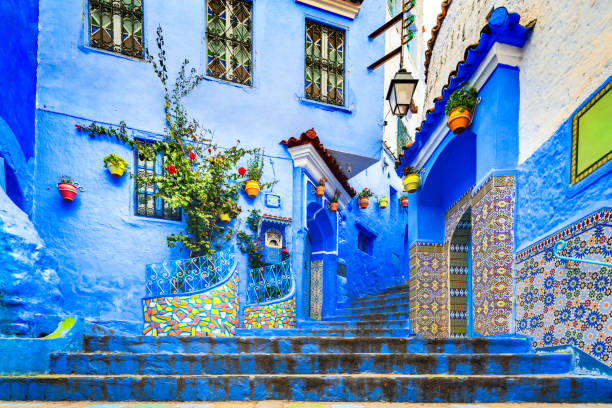 Chefchaouen, Morocco. Blue staircase and wall decorated with colourful flowerpots. Chefchaouen, Morocco. Blue staircase and wall decorated with colourful flowerpots, Chefchaouen medina, North Africa travel destination. chefchaouen stock pictures, royalty-free photos & images