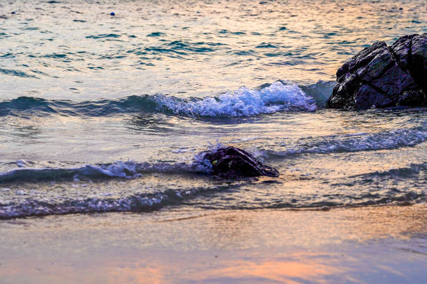Sea waves lash line impact rock on the beach with summer background, wave surface