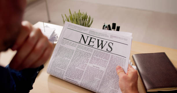 istock Businessman Reading Newspaper At Office Desk 2148115165