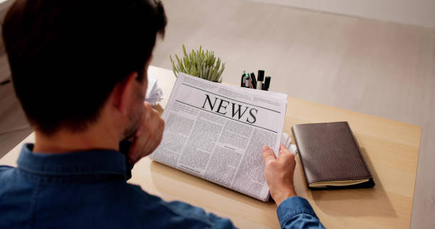 istock Businessman Reading Newspaper At Office Desk 2148115167