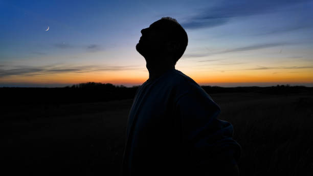 istock Man looking at night skies, observing celestial objects, Moon, planets, meteors. 2148115493