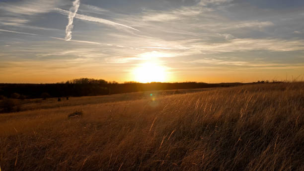 istock Sunset with some clouds and golden colored landscape. 2148115622
