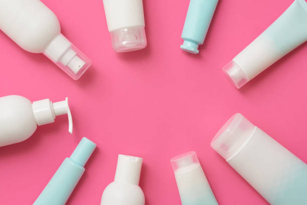 istock Tubes with cosmetic products on pink background with text space in center 2148115721