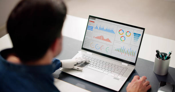 istock Man With Prosthetic Hand Working On Laptop 2148115753