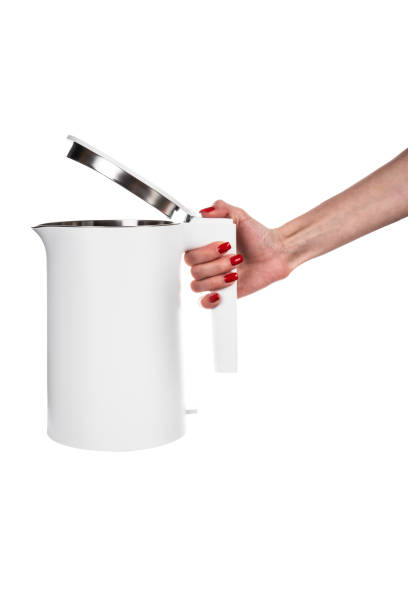 istock New modern electric kettle in female hand isolated on white background 2148116190