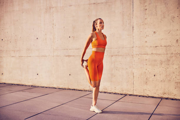 istock Athletic female runner stretching thigh 2148117102