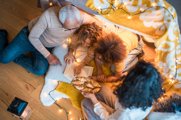 istock Diverse Family Reading Book Together Indoors 2148117596