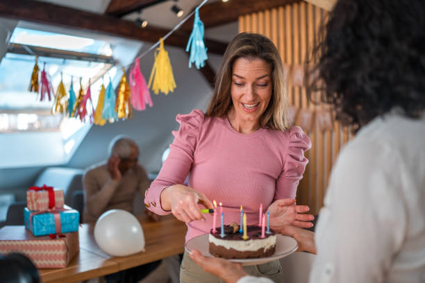 istock Diverse Family Celebrates Birthday with Cake Indoors 2148117629