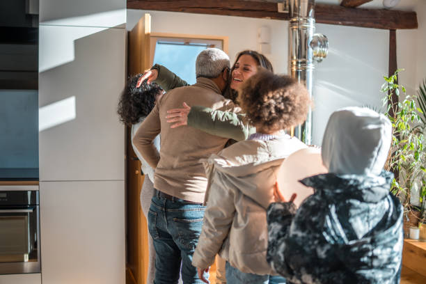 istock Diverse Family Embracing Indoors 2148117655