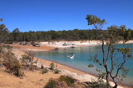 Boat ramp, launch area at Logue Brook Dam (Lake Brockman). Framed by trees. Turquoise colored water. Water sports.