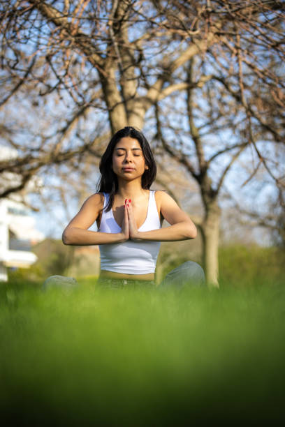 istock Young woman is meditating in nature. 2148118167