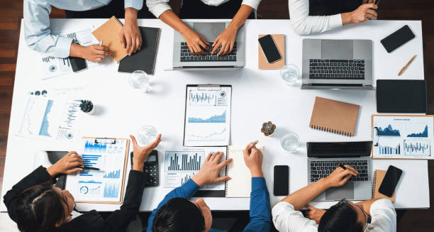 istock Analyst team utilizing BI Fintech to analyze financial data at table. Prudent 2148119034