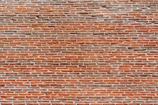background of an old wall built with red bricks