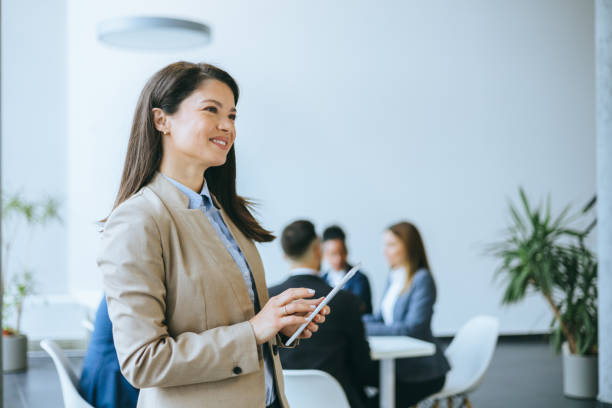 Confident Businesswoman Holding Tablet