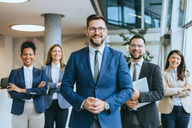 istock Male business leader with team in background 2148122363