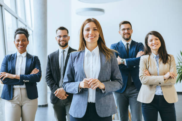 istock Smiling professional woman with supportive team 2148122367