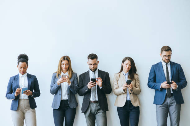 istock Business colleagues engaged with smartphones 2148122369