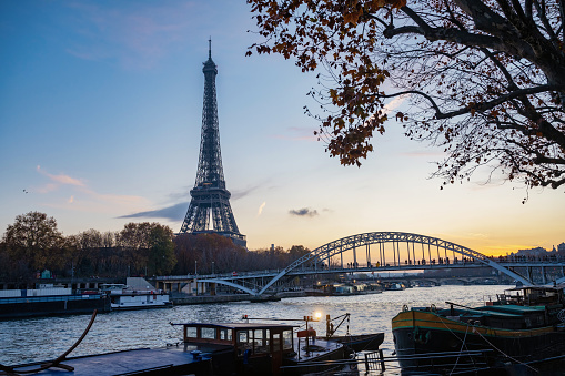Paris Eiffel Tower and river Seine with sunrise sun in Paris, France. Eiffel Tower is one of the most iconic landmarks of Paris, panorama