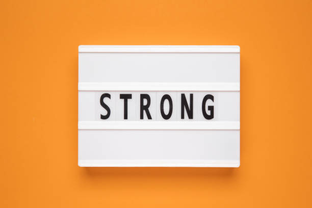 istock The word strong on lightbox isolated orange background. 2148123933