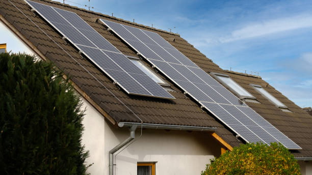 istock Home solar panel. Alternative energy is used for heating and water heating. Eco-friendly alternative energy for house. Residential family house suburban. Brown tile roof of home with solar panels. 2148123994