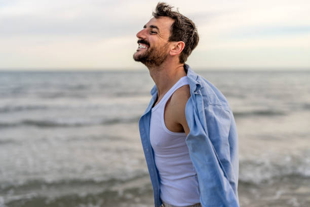 istock Young man enjoying a day at the beach 2148124332