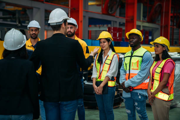 istock Team engineers and foreman stack hand and shake hands to show success at factory machines. Worker industry join hand for collaboration. 2148124827