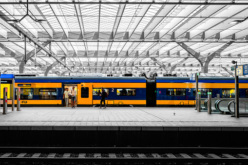 Rotterdam, The Netherlands - April 6th, 2024: NS Train at Rotterdam Central train station, The Netherlands. The colors are yellow and blue of the Dutch trains at the Netherlands.