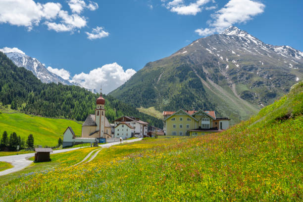 Alpine village surrounded by mountains and fields in the Swiss Alps