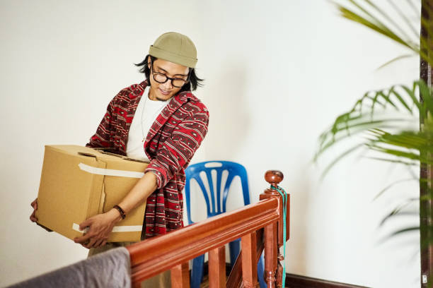 istock Handsome young man moving in his new home 2148126966