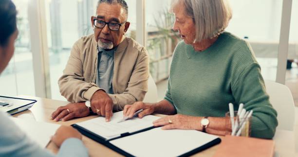 istock Conversation, lawyer or old couple with will, contract or document for retirement funding or life insurance. Plan, advisor or married elderly clients with legal form or title deed agreement with help 2148127015
